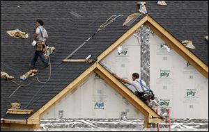 Roofers work on a house in Pennsylvania. The U.S. inventory of new houses on the market fell to a record low of 175,000 in April. 