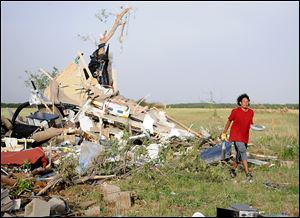 Harley Voyager salvages items from the home of Jeremy and Crystal Sullins after a massive tornado destroyed the double-wide trailer home northwest of Longdale, Okla. The Sullins' family was returning home after a trip to Oklahoma City, and was not injured. 
