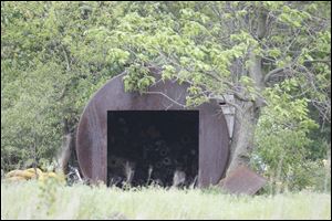 This steel tank, at one time used underground for gasoline, housed Jerry Brummett's Packard for 44 years. Mr. Brummett said he rolled the car inside and welded the tank shut.