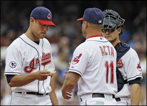 Cleveland Indians relief pitcher Frank Herrmann hands the ball to manager Manny Acta (11) as he leaves in the sixth inning Wednesday. Hermann gave up five runs in the inning before being relieved by Chad Durbin.