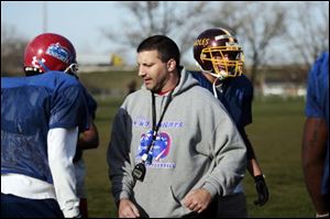 In this 2009 file photo coach Dave Calabrese talks with players of the Northwest Ohio Knights semipro football team during practice.