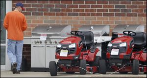 A customer looks over a display of grill sand lawn tractors at a Sears Hardware store in northeast Ohio's Geauga County.