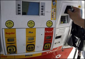 Customer Daniel Dona pays with his credit card for $4.13 a gallon at a Shell gas station in Menlo Park, Calif., in March.