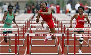Rogers junior Brianna Scott-Glover, center, has swept titles in the 100-meter hurdles and 300-meter hurdles three straight years in the City League and district meets.
