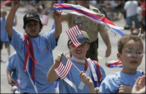 Members of Cub Scout Pack 512 at Lincoln Elementary School in Monroe, Mich., walk in the 2008 Monroe Memorial Day parade in this file photo.