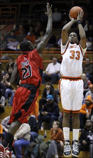 Bowling Green State University player Danny McElroy (33) takes a shot against  Ball State's Chris Bond (20) during a Feb. 9 game at BGSU.