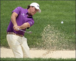 Phil Mickelson hits out of a sand trap on the third hole during the second round of the 2010 Bridgestone Invitational golf tournament at Firestone Country Club in Akron, Ohio.