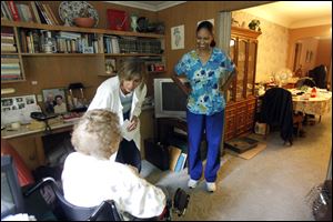Home health care aide Laquita Jackson, right, and supervisor Laura Suder say good-bye after a visit to a Sylvania-area patient. The field of home health aides is one that has seen employment growth in the Toledo area.