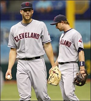 Indians starting pitcher Justin Masterson, left, and third baseman Adam Everett react after an infield single by the Rays' Reid Brignac during the third inning.