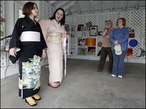 Kerry Porter, right, of Maumee teaches a kimono class last month at Schedel Arboretum & Gardens near Elmore. Ms. Porter is dressing Ashley Pruchinski of Cleveland in a traditional Japanese kimono. 
