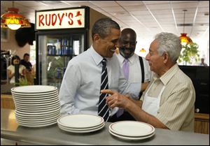 President Barack Obama visits Harry Dionyssiou at Rudy's Hot Dog at 946 W. Sylvania Ave., Toledo, on Friday as Toledo Mayor Mike Bell looks on.