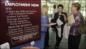 Glynis Davies, left, from Hartman Personal Services, talks with job seekers Christine Marciante and Maxine Janke, right, at the Jobapalooza job fair May 25 at Lake Erie College, in Painesville, Ohio. 