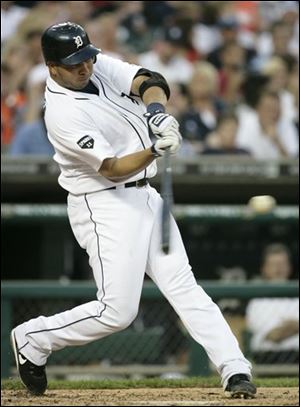 The Tigers' Jhonny Peralta hits a two-run home run to drive in Victor Martinez and take a 5-1 lead over the Seattle Mariners Saturday in Detroit. 