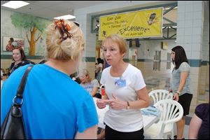 Emily Baker, principal at East Side Elementary in Chattanooga, Tenn., talks with a parent who was collecting her child’s report card on the last day of school. Ms. Baker says the school was a mess when she took over in 1997.