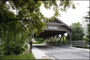 The upscale Sleepy Hollow area agreed by a 92 percent vote several years ago to rebuild its distinctive covered bridge over Ten Mile Creek, the cost of which is being assessed to the property owners. Currently, the homeowners association is trying to cut costs.