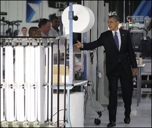 President Barack Obama shakes hands with workers as he tours the manufacturing facilities of Cree, a leading manufacturer of energy-efficient LED lighting in Durham, N.C. 