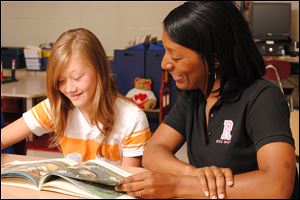 Reading consultant Roxanne Anthony reads with Jensen Sudderth at Red Bank School in Chattanooga, Tenn. Ms. Anthony says the staff at the school is improving, and teachers say they’ve seen the growth.