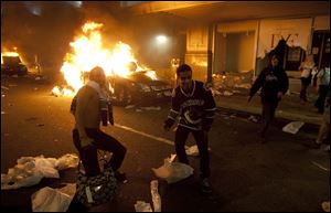 Vancouver Canucks hockey fans take part in a riot Wednesday in downtown Vancouver, British Columbia.