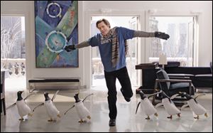 Jim Carrey dances with his penguins in the film 'Mr. Popper's Penguins.'
