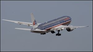 An American Airlines airplane takes off at Miami International Airport in Miami.