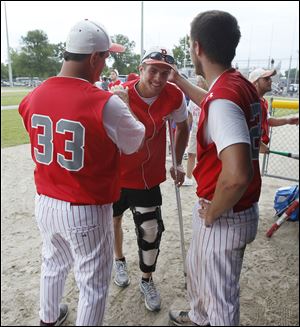 Injured Bedford catcher Jared Kujawa, center, shares the win with Jack Eaton, left, and Troy Przbylek.