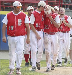 Bedford players Mike Blake (49), Kyle Kuhr (21), Troy Przybylek (23), and Zach Mayo (14) walk off the field after losing the Division 1 state baseball final to Rockford. The Mules finished with a 36-7 record.