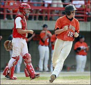 Bedford’s Troy Przybylek watches as Rockford’s Brandon Nostrant scores what proved to be the the winning run in the sixth inning.