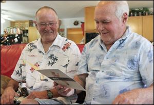 David Sowards watches his brother Daniel Miller read the card he gave him in Florida for his 70th birthday.
