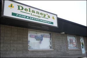 Delaney’s Lounge on West Alexis Road is one of three bars that together owe more than half the $245,000 in unpaid smoking-violation fines in Lucas County. Opponents of the fines say they should be levied against smokers, not business owners. 