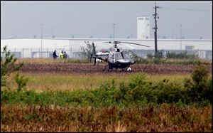 An Ohio Highway Patrol helicopter prepares to take off after landing near a double fatal air crash at the Rickenbacker Airport Sunday.