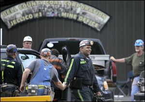 Pernell Witherspoon is congratulated after being rescued from within the Jellico Mine No 1. in Middlesboro, Ky. Three mine maintenance workers were freed and appeared to be in good health Monday after being trapped for 14 hours in the flooded southeastern Kentucky mine.
