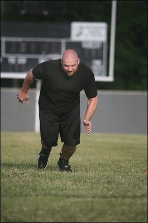 Chris Morris has been working out on the Bedford High football field while he waits for the lockout to end. He was drafted by the Raiders in 2006 after playing on the offensive line at Michigan State.