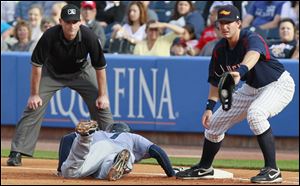 Toledo first baseman Ryan Strieby tries to tag Columbus Clippers' Ezequiel Carrera (7) on a dive back in the first inning Thursday.