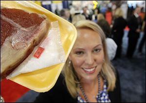 An electronic label in a meat soaker pad set to trigger an alarm at a store doorway is displayed at a National Retail Federation conference.