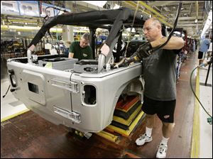 Steve Guerrette works on a Jeep Wrangler at Chrysler's North Assembly Complex in Toledo in November. Chrysler says Wrangler production is up 19 percent to nearly 71,000 vehicles a year.