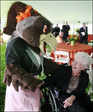 BGSU's female mascot, Frieda Falcon, gets a laugh Thursday from university President Carol Cartwright at a farewell event on the lawn near University Hall. President Cartwright leaves Thursday. 