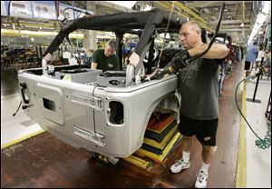 Steve Guerrette works on a Jeep Wrangler at Chrysler's North Assembly Complex in Toledo in November. Chrysler says Wrangler production is up 19 percent to nearly 71,000 vehicles a year.
