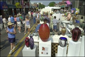 Crowds inspect works on display at a previous Ann Arbor Street Art Fair. This year's event will be July 20-23.