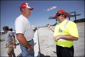 Bob Zimmerman, left, listens to CSX employee Chad Main explain operations at the freight-transfer facility.