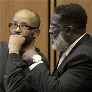 Defense attorney Rufus Sims, right, talks with Anthony Sowell during the trial Thursday. If convicted for murdering 11 women, he could face the death penalty.