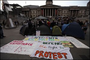 Police speak to activists who put up tents in Trafalgar Square, London, in advance of the strikes taking place in Britain on Thursday.  
