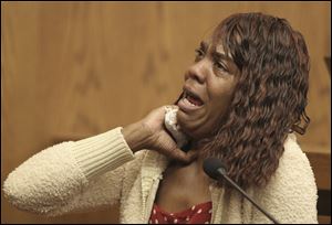 Gladys Wade demonstrates how she says she was choked by Anthony Sowell as she testifies during his trial Thursday in Cleveland. 