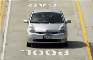 Hybrids such as this Toyota Prius on I-405 in Los Angeles will have to return to using  regular traffic lanes.