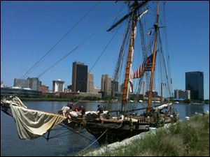 Crew members stow sails on the Lynx as the privateer ship arrives Thursday in Toledo.