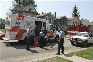Emergency crews respond to a report of a midday shooting of a woman in the 800 block of Locust Street in North Toledo.