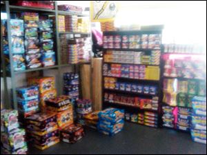 Fireworks seized from a Claybourne Avenue home, shown in a photo from the State Fire Marshal's Office, are stacked neatly on shelves in the garage, where authorities say the homeowner sold pyrotechnics.