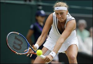 Petra Kvitova of the Czech Republic returns a shot to Victoria Azarenka. She is the first left-handed woman in a major final since 1998.