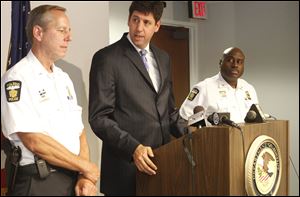 Steven M. Dettelbach, U.S. Attorney for the Northern District of Ohio, center, speaks about the new V-GRIP plan that has been implemented. He is flanked by Lt. Brad Weis, left, and Deputy Chief Derrick Diggs.