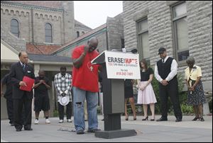 The Rev. Rick Morris prays at St. Martin de Porres Church on West Bancroft Street. Religious leaders and community members said they could not stand by while youths continue to take guns onto the streets.