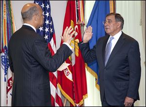 Leon Panetta, right, is sworn is as Defense Secretary by Pentagon General Counsel Jeh Johnson on Friday at the Pentagon.  